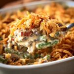 Savory casserole with crispy fried onion topping and creamy vegetable filling.
