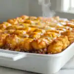 Tater Tot casserole with melted cheese and savory ground beef, perfect for a comforting family dinne.